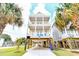 Three-story beach house featuring multiple balconies and covered parking at 1614-B S Ocean Blvd., Surfside Beach, SC 29575