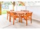 Outdoor patio featuring a wooden dining table with six chairs, perfect for Gathering gatherings at 1614-B S Ocean Blvd., Surfside Beach, SC 29575