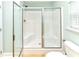 Bathroom featuring an enclosed white shower with glass doors and tiled flooring at 1614-B S Ocean Blvd., Surfside Beach, SC 29575