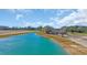 Aerial shot of the bright blue pond next to the charming house at 1751 Nichols Hwy., Aynor, SC 29511
