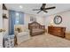 This cozy Bedroom features a wooden crib, comfortable chair, and natural light at 1751 Nichols Hwy., Aynor, SC 29511