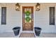 Close-up of the beautiful front door, adorned with double wreaths and flanked by stylish outdoor lanterns at 1751 Nichols Hwy., Aynor, SC 29511