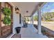 Welcoming front porch with rocking chairs, elegant columns, and a beautifully decorated front door with wreaths at 1751 Nichols Hwy., Aynor, SC 29511