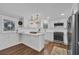 Bright kitchen boasts white cabinetry, stainless steel appliances, and modern lighting fixtures at 1751 Nichols Hwy., Aynor, SC 29511