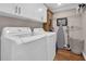 Functional laundry room with modern washer and dryer units and ample cabinet space at 1751 Nichols Hwy., Aynor, SC 29511