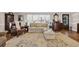 Bright living room featuring stylish seating, shuttered windows, hardwood floors, and tasteful decor elements at 1751 Nichols Hwy., Aynor, SC 29511
