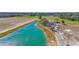 Wide view of a pond and yard in front of the home, with a beautiful bright blue color at 1751 Nichols Hwy., Aynor, SC 29511