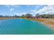 Aerial perspective of a turquoise pond with home in the background, surrounded by fields at 1751 Nichols Hwy., Aynor, SC 29511