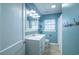 Bathroom vanity, mirror, and a shower/tub combo featuring blue walls at 1916 Jasper St., Georgetown, SC 29440