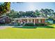Charming brick home with well-manicured lawn, covered parking, and a cozy front porch at 1916 Jasper St., Georgetown, SC 29440