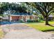 Charming brick ranch home with a well-manicured lawn, front porch, and mature trees at 1916 Jasper St., Georgetown, SC 29440