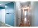 Hallway with hardwood floors, doors, and hooks on a blue accent wall at 1916 Jasper St., Georgetown, SC 29440