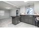 Kitchen with dark countertops, gray cabinets, and stainless steel appliances at 1916 Jasper St., Georgetown, SC 29440