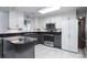 Well-lit kitchen with stainless appliances, marble floors, dark countertops and gray cabinets at 1916 Jasper St., Georgetown, SC 29440