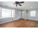 Bright living room featuring hardwood floors, ceiling fan, neutral paint, and large windows at 1916 Jasper St., Georgetown, SC 29440