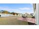 Expansive backyard featuring a large patio, a spacious lawn, and mature trees at 195 Cupola Dr., Longs, SC 29568