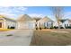 Charming home featuring a well-manicured lawn, beautiful landscaping, and a two-car garage at 195 Cupola Dr., Longs, SC 29568