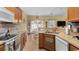 Bright kitchen featuring a sink, cabinets, tile backsplash, stainless steel appliances, and eat-in area at 195 Cupola Dr., Longs, SC 29568