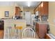 The open kitchen bar area with seating, abundant cabinet space, and modern appliances at 195 Cupola Dr., Longs, SC 29568
