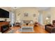 Inviting living room featuring hardwood floors, neutral paint, a ceiling fan, and a fireplace at 195 Cupola Dr., Longs, SC 29568