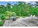 Outdoor patio with seating area, barbecue grill, and lush landscaping at 196 Rose Water Loop, Myrtle Beach, SC 29588