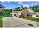 Charming home featuring a well-manicured lawn, brick accents, double garage, and long driveway at 196 Rose Water Loop, Myrtle Beach, SC 29588