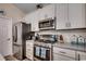 Stainless steel appliances stand out in this bright kitchen with white cabinetry and lots of counter space at 196 Rose Water Loop, Myrtle Beach, SC 29588