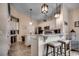 An inviting kitchen featuring white cabinets, an island with stool seating, and pendant lighting at 196 Rose Water Loop, Myrtle Beach, SC 29588