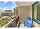 Relaxing balcony view with a blue chair, palm trees and condo buildings at 200 76Th Ave. N # 410, Myrtle Beach, SC 29572