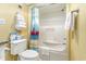 Clean bathroom with a toilet, towels, and a shower featuring a flamingo-themed curtain at 200 76Th Ave. N # 410, Myrtle Beach, SC 29572