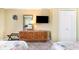 Cozy bedroom featuring a dresser with a mirror and a mounted TV for entertainment and convenience at 200 76Th Ave. N # 410, Myrtle Beach, SC 29572