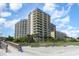 Beachfront building with multiple balconies and lush vegetation near a boardwalk at 200 76Th Ave. N # 410, Myrtle Beach, SC 29572