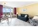 Cozy living room with tile floors, comfortable seating, and sliding door to the balcony at 200 76Th Ave. N # 410, Myrtle Beach, SC 29572