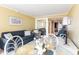 Open-concept living area with a sofa, dining table, and access to the kitchen at 200 76Th Ave. N # 410, Myrtle Beach, SC 29572