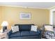 Comfortable living room with a sofa, accent chair, and beach-themed decor at 200 76Th Ave. N # 410, Myrtle Beach, SC 29572