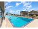 Outdoor pool showcasing clear blue water and surrounding lounge chairs under a sunny sky at 200 76Th Ave. N # 410, Myrtle Beach, SC 29572