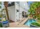 Backyard oasis with a pool, tropical plants, outdoor shower, and a shaded bar area for entertaining at 209B Woodland Dr., Murrells Inlet, SC 29576