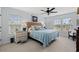 Serene bedroom features light blue walls, two windows, ceiling fan, and a comfortable bed with blue accents at 209B Woodland Dr., Murrells Inlet, SC 29576