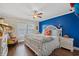 Charming bedroom featuring a bright blue accent wall, white furniture, and a cozy, colorful chair at 209B Woodland Dr., Murrells Inlet, SC 29576