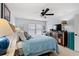 Comfortable bedroom features a bed with blue bedding, a ceiling fan, and a unique decorative cabinet at 209B Woodland Dr., Murrells Inlet, SC 29576