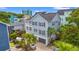 Inviting exterior with light blue siding, a two-story porch, and palm trees for that relaxed, coastal feel at 209B Woodland Dr., Murrells Inlet, SC 29576