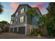 Charming three-story home with a three-car garage, lovely landscaping, and a beachy, elevated design at 209B Woodland Dr., Murrells Inlet, SC 29576