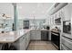 Bright and spacious kitchen with a large island, stainless steel appliances, and seamless flow to the living room at 209B Woodland Dr., Murrells Inlet, SC 29576