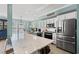 Modern kitchen with a large island, stainless steel appliances, and elegant white cabinets at 209B Woodland Dr., Murrells Inlet, SC 29576