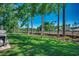Well-manicured backyard with lush green grass and tall trees, enclosed by a black metal fence at 2131 Timmerman Rd., Myrtle Beach, SC 29588