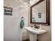 Charming powder room with pedestal sink, decorative mirror and beach themed decor at 2131 Timmerman Rd., Myrtle Beach, SC 29588
