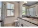 Bathroom with granite countertop, white cabinets, and decorative mirror with window view at 2131 Timmerman Rd., Myrtle Beach, SC 29588