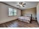 Bedroom with a rustic bed frame, wood floors and neutral colored walls at 2131 Timmerman Rd., Myrtle Beach, SC 29588