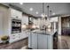 Stylish kitchen features white cabinets, stainless appliances, granite countertops, and a large island at 2131 Timmerman Rd., Myrtle Beach, SC 29588