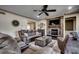 Cozy living room featuring a stone fireplace and comfortable, reclining seating with a ceiling fan at 2131 Timmerman Rd., Myrtle Beach, SC 29588